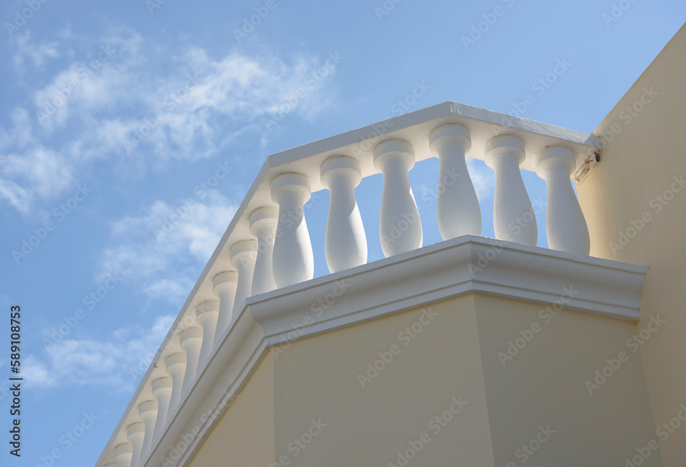 White concrete balustrade on blue sky background.