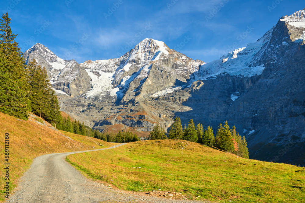 Mountains view with Monch peaks from hiking trail near Wengen alpine village in Switzerland.