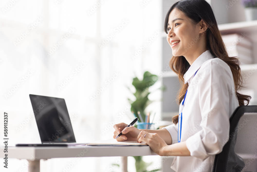 Charming Young asian businesswoman sitting on laptop computer in the office, asian employee business making report calculating balance Internal Revenue Service checking document. Charming Young asian businesswoman sitting on laptop computer in the office, asian employee business making report calculating balance Internal Revenue Service checking document.