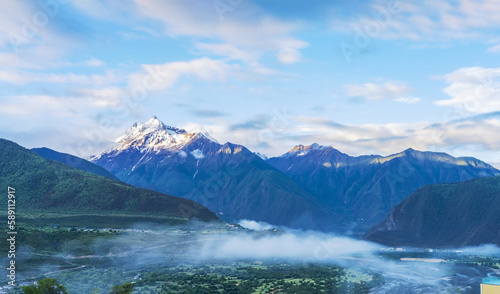 The beautiful scenery of the snowy mountains and villages in the Nyingchi Mountains of Tibet, China on June 11, 2022