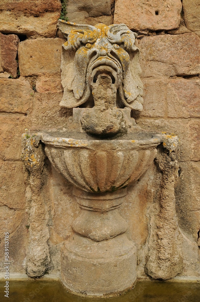 Stone fountain on the wall of the Fontfroide Abbey, Languedoc-Roussillon, France