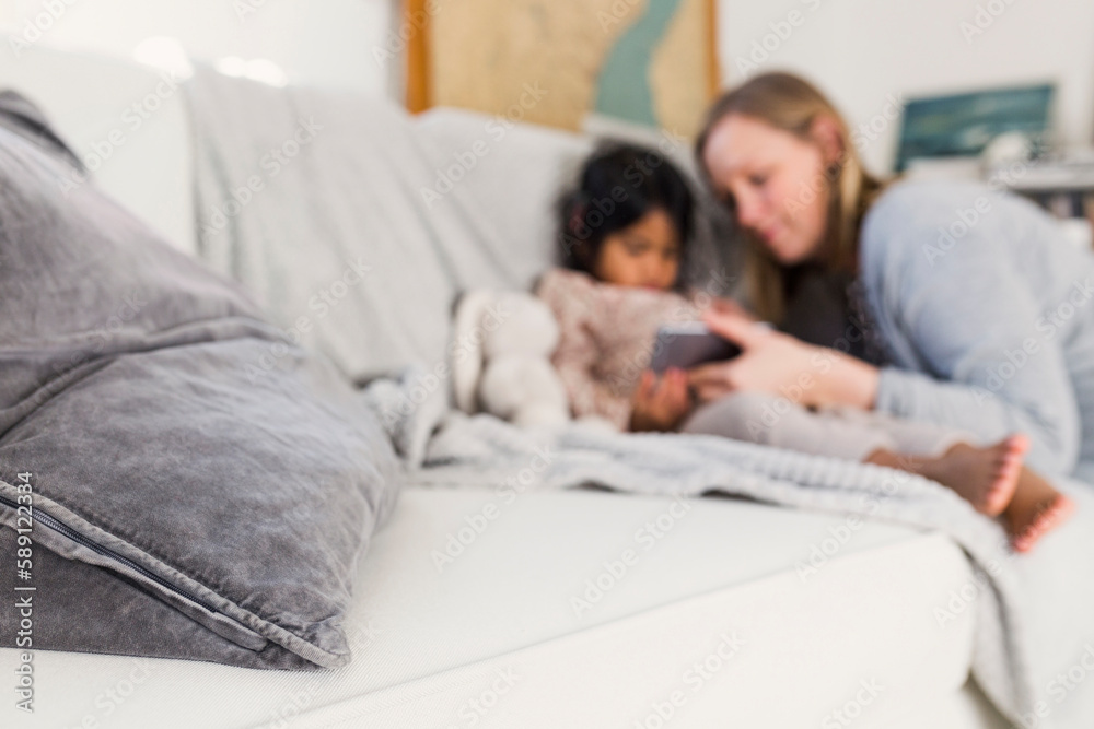 Mother and daughter (4-5) looking at smart phone Mother and daughter (4-5) looking at smart phone
