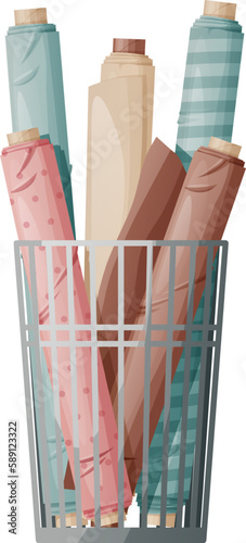 Rolls of multi-colored fabric in a metal basket in a sewing workshop or textile store. Sewing accessories.