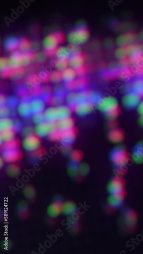 Wallpaper Mural Vertical video. Bokeh light. Neon glow. Digital flare. Defocused fluorescent purple pink blue green color sparkles glare motion on dark black abstract background. Torontodigital.ca