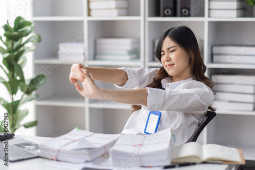 Asian women are stressed or has sore throat at office while working on laptop, Tired asian businesswoman with headache at office, feeling sick at work, copy space