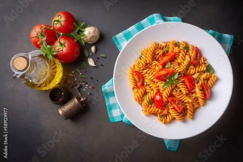 Fusilli pasta, spiral or spirali pasta with tomato sauce - Italian food style photo