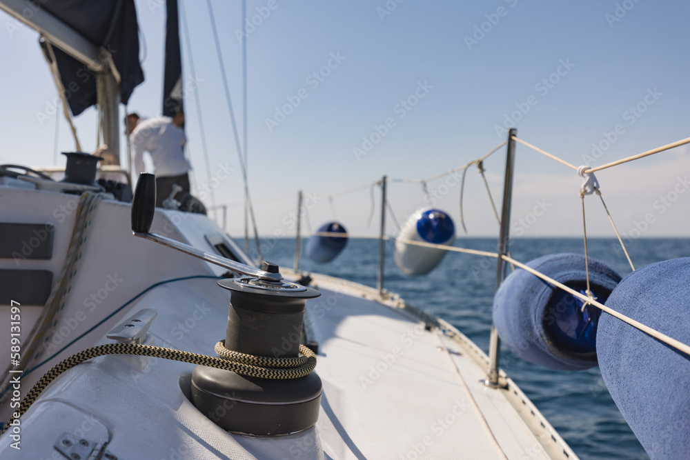 Sailboat yacht sailing in the sea at blue summer sky