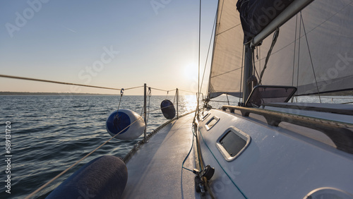 Sailboat yacht sailing in the sea at colorful sunset © 24K-Production