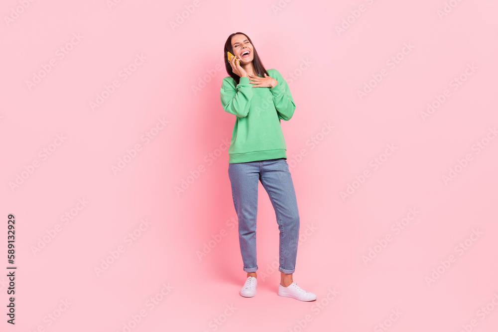 Full length photo of joyful positive glad lady hand chest wear trendy clothes chatting speaking telephone isolated on pink color background Full length photo of joyful positive glad lady hand chest wear trendy clothes chatting speaking telephone isolated on pink color background