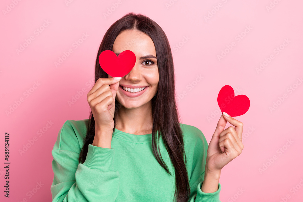 Portrait of cute smile hispanic lady wear stylish green shirt eye paper postcard love shape heart valentine day isolated on pink color background Portrait of cute smile hispanic lady wear stylish green shirt eye paper postcard love shape heart valentine day isolated on pink color background