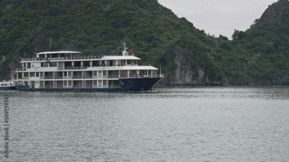Cruise Ship Tour With Tourists At Halong Bay In Tropical Island In Vietnam. - static shot Cruise Ship Tour With Tourists At Halong Bay In Tropical Island In Vietnam. - static shot