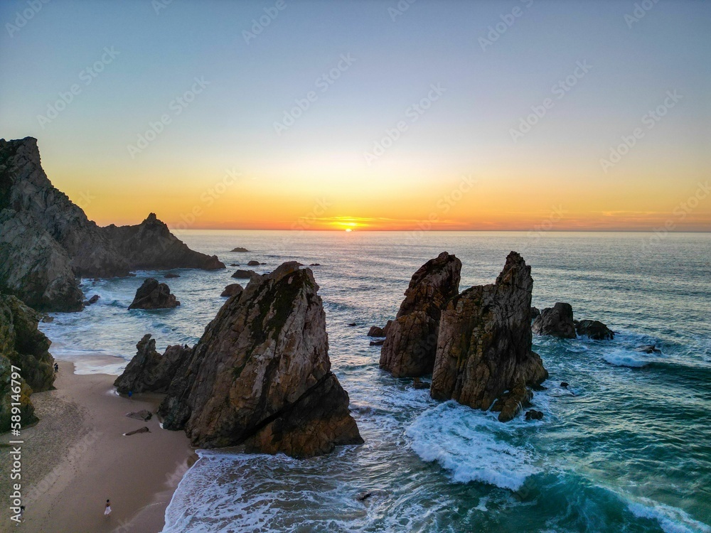 Scenic view of the rock formations in Ursa beach during a beautiful summer day in Portugal