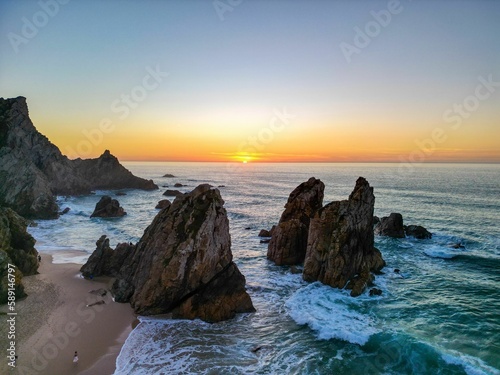 Scenic view of the rock formations in Ursa beach during a beautiful summer day in Portugal