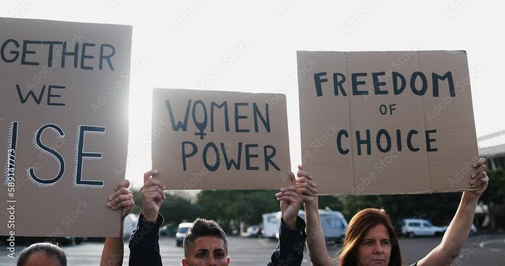 Diverse women doing demonstration for female rights on city street - Feminism concept - Main focus on center banners