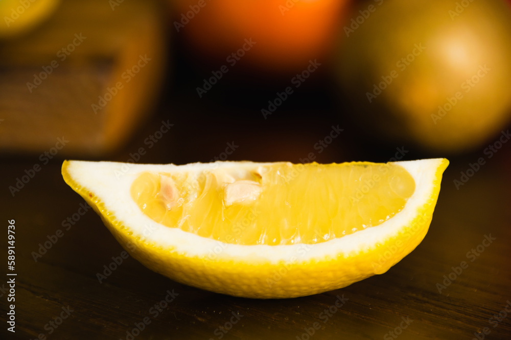Fruits on a cutting board on a dark background. A lemon slice close-up macro Fruits on a cutting board on a dark background. A lemon slice close-up macro