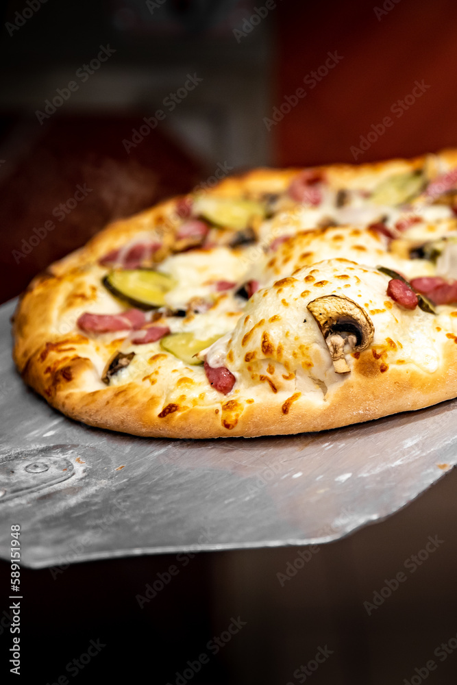 chef baker making pizza at kitchen. Put on landing shovel and send it to the oven. chef baker making pizza at kitchen. Put on landing shovel and send it to the oven.