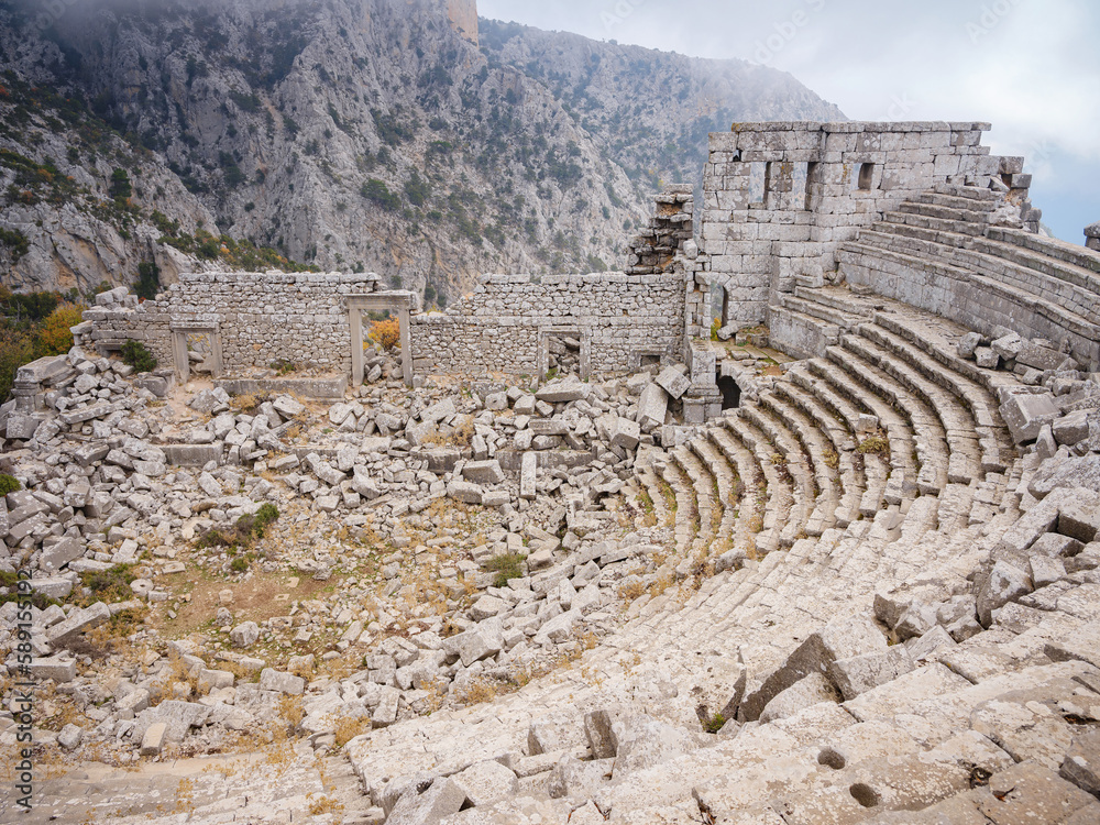 Autumn walk by ancient amphitheatre in city Termessos Ancient City, Turkey. Turkeys most outstanding archaeological sites and one of main tourist center.