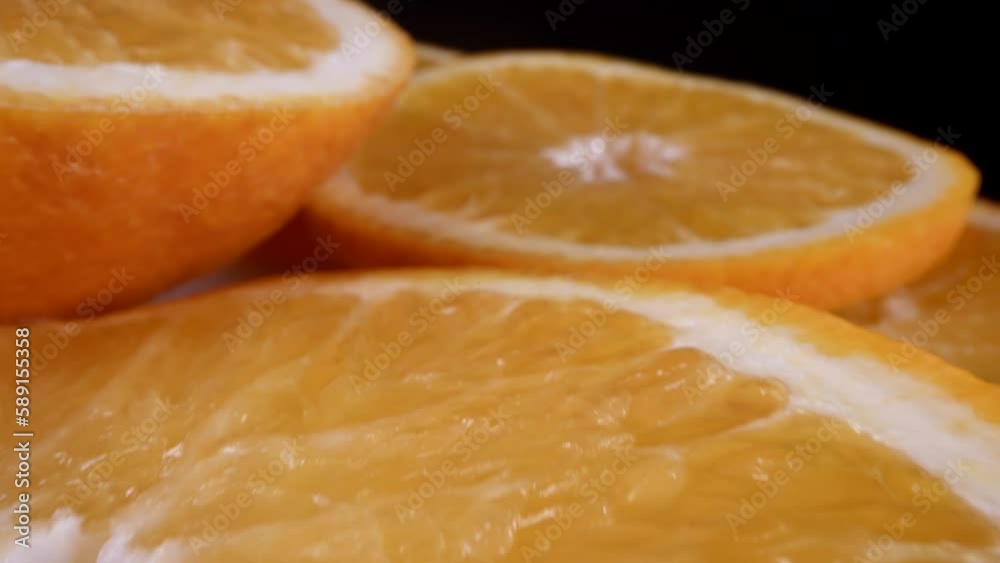 tasty fruit dessert, macro shot with cut orange in black background, juicy citrus fruit on plate tasty fruit dessert, macro shot with cut orange in black background, juicy citrus fruit on plate