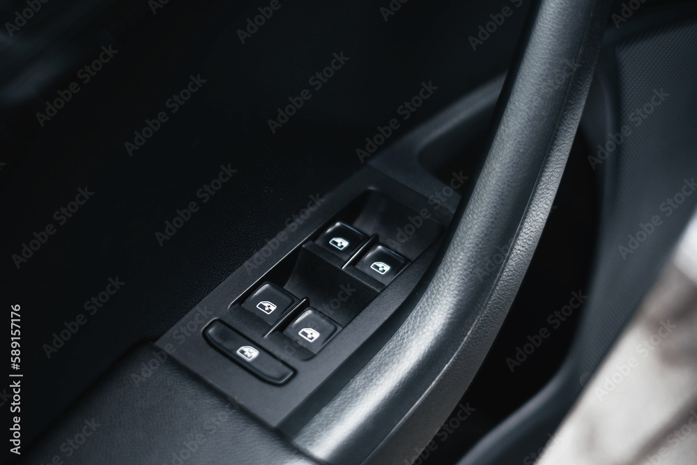 Modern black car interior, black car doors with window control buttons, details interior. Modern black car interior, black car doors with window control buttons, details interior.