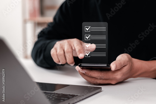 Checklist concept. Businessman using smartphone to fill online survey, digital form checklist.