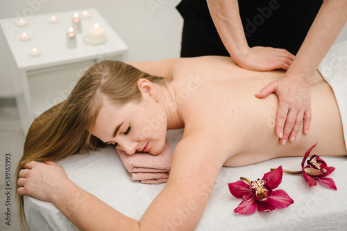 Masseuse gives a relaxing massage in spa center. Body shaping massage, lymphatic drainage, manual and aesthetic procedures in salon. Aromatherapy. Concept of massage spa treatments. Closeup.