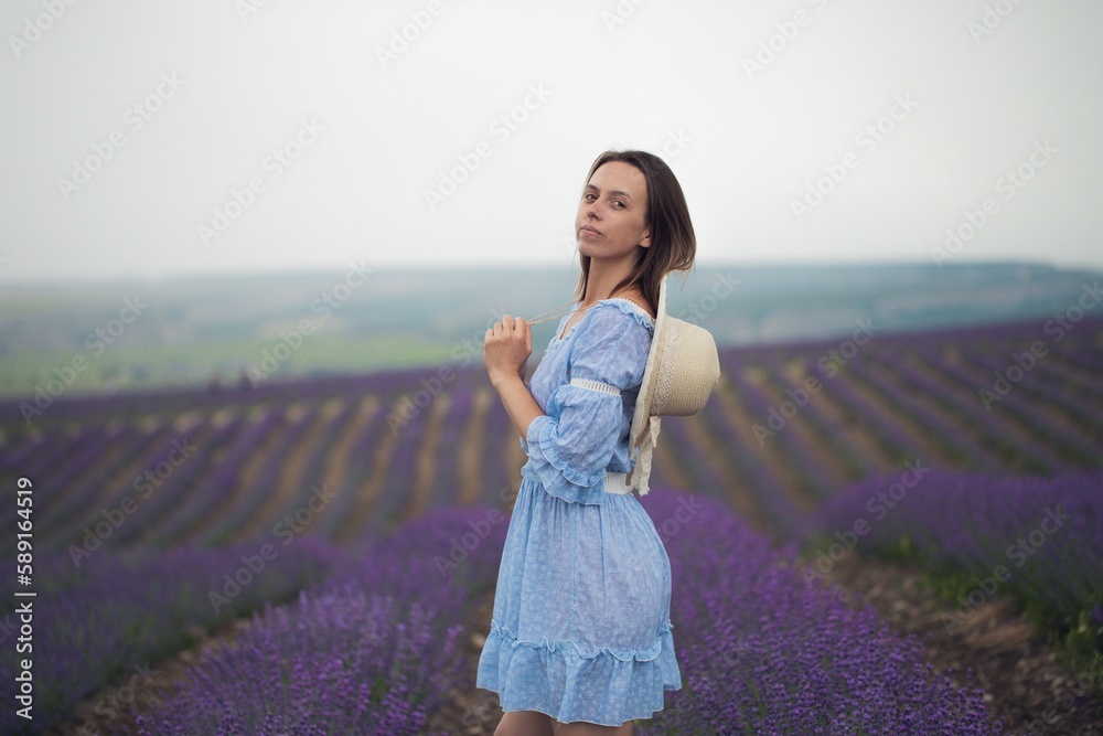 A young girl in a dress walks in a lavender field. Aromatherapy.The model at lavender field. A young girl in a dress walks in a lavender field. Aromatherapy.The model at lavender field.