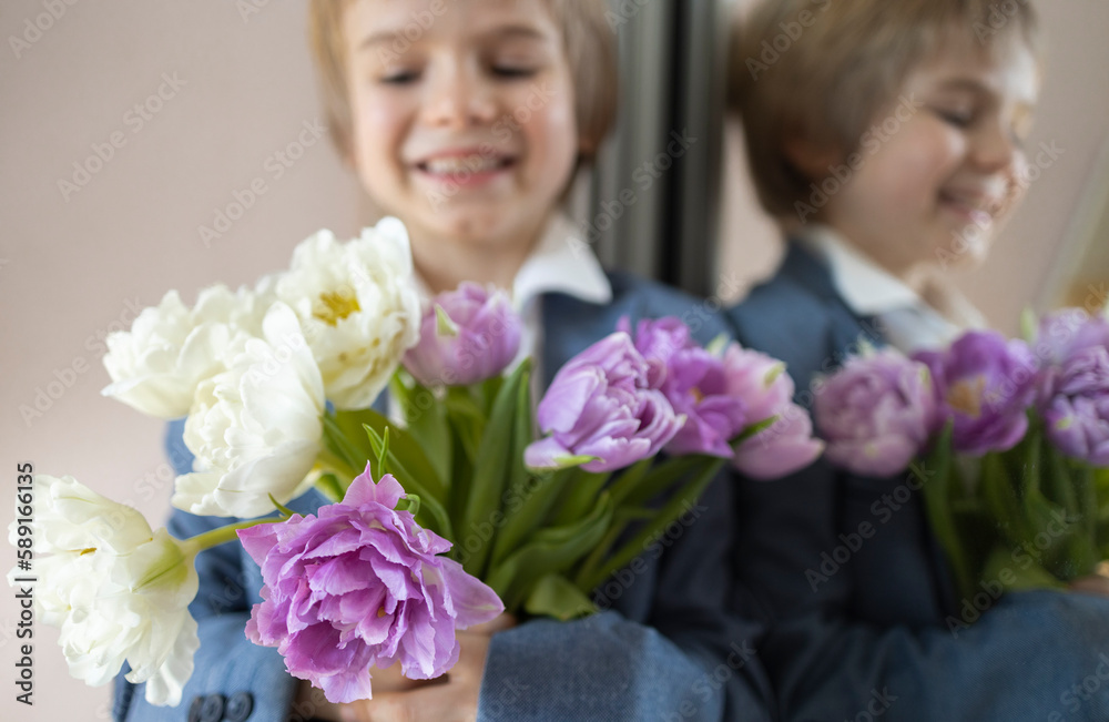beautiful bouquet of white and lilac tulips in foreground, the face of cute smiling boy near the mirror in defocus. Mother's Day, Valentine's Day, Birthday. Festive mood, pleasant flower surprise