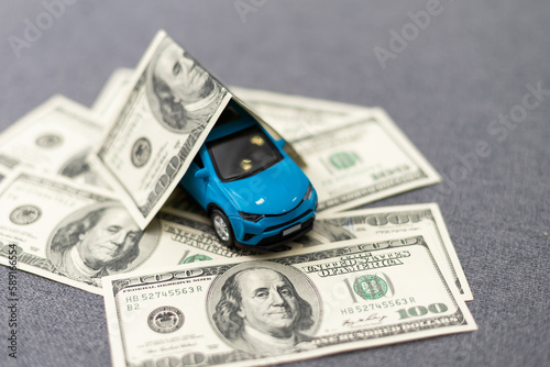 flat lay toy car, toy house, keys and money on the table