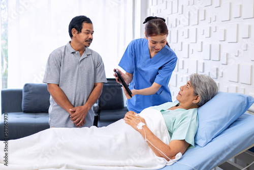 Wallpaper Mural Nurse showing medical insurance data in digital tablet near bed of patient with relative stand by Torontodigital.ca