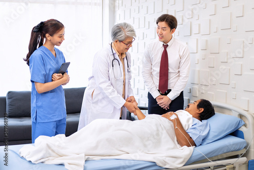 Hospital treatment room relative visit patient lay on bed doctor explain update illness condition