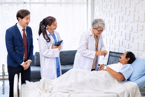 Hospital treatment room relative visit patient lay on bed doctor use stethoscope measurement