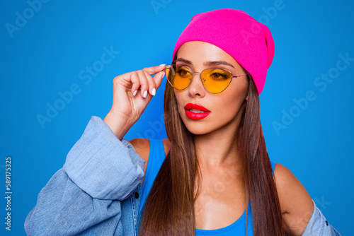 Whats on her mind Close up portrait of young brunette model looking away, wearing casual outfit isolated on pink vivid background