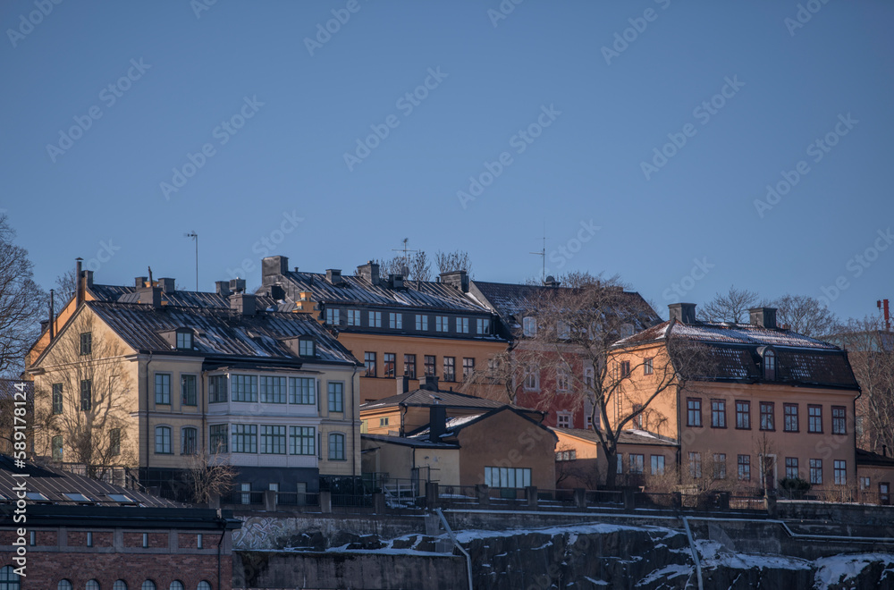 Old houses on a cliff in the district Södermalm at the bay Strömmen, a sunny spring day in Stockholm