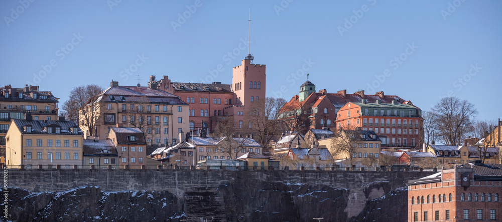 Old houses on a cliff in the district Södermalm at the bay Strömmen, a sunny spring day in Stockholm