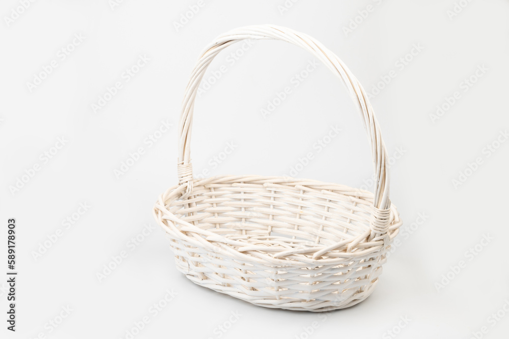 White wicker basket on white background. Used for storing items and reduce the waste of plastic bags.