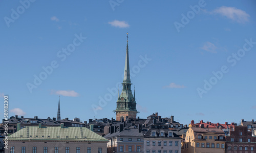 Roofs of old houses and church tower in the old town Gamla Stan, a sunny spring day in Stockholm