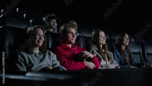 People applaud after the end of the movie to the cinema and disperse. A fascinating movie, the premiere of an action movie