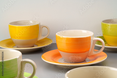 Colorful clay ceramic cups on gray background