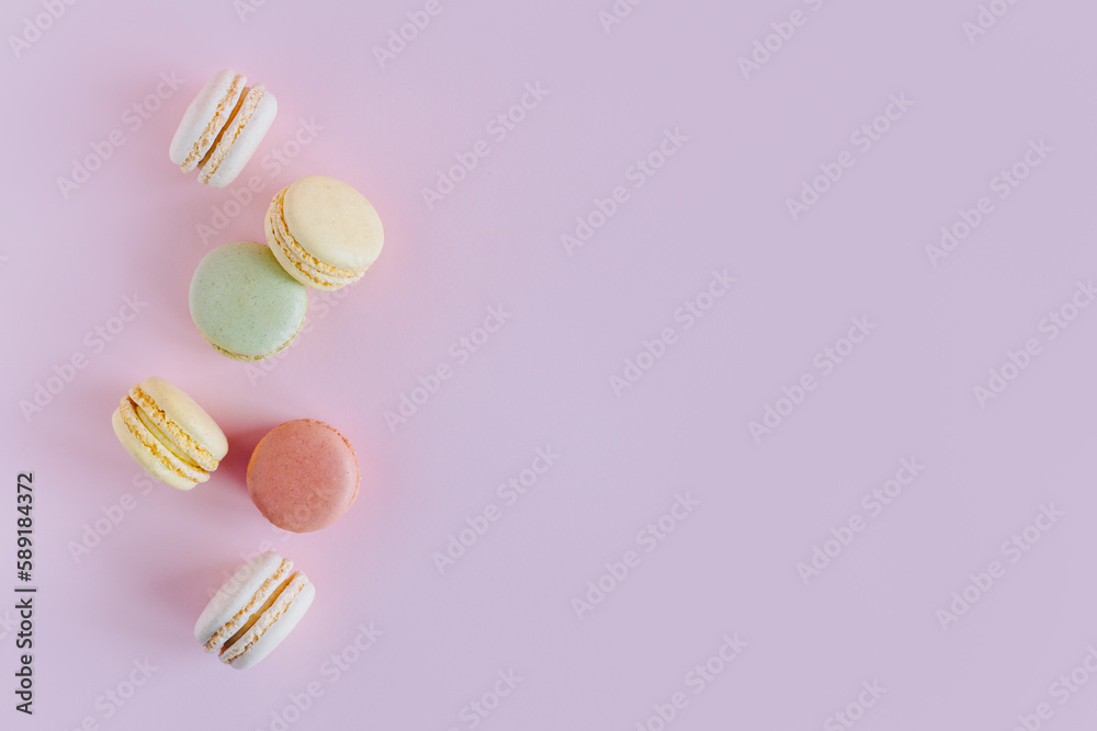 Tasty french macarons on a pink pastel background. Tasty french macarons on a pink pastel background.
