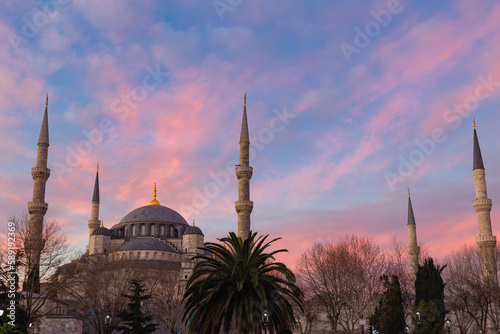 Blue Mosque or Sultanahmet Mosque at sunrise with pink and orange clouds