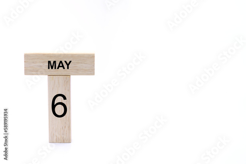 May 6 displayed wooden letter blocks on white background with space for print. Concept for calendar, reminder, date. 