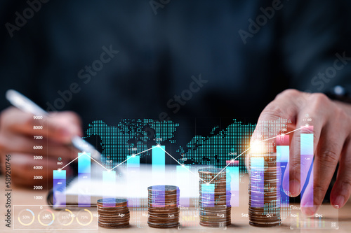 businessman carefully monitored statistics of his earnings, value of his investments, stacked coins to calculate his profit, make informed decisions grow his income through strategic investments.