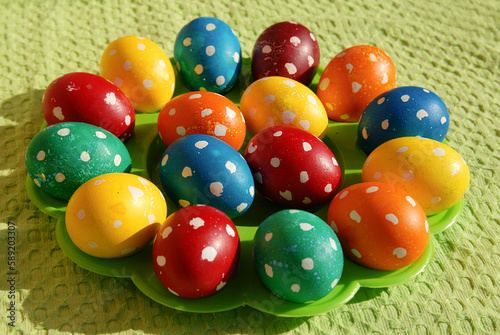 Colorful Easter eggs on country table on green tablecloth. Background and texture.Easter symbol. Spring festive concept.