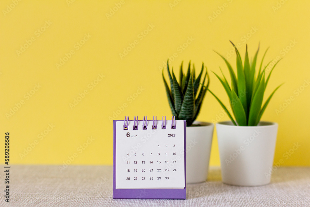 Desktop calendar for June 2023 on a yellow background. - obrazy, fototapety, plakaty 