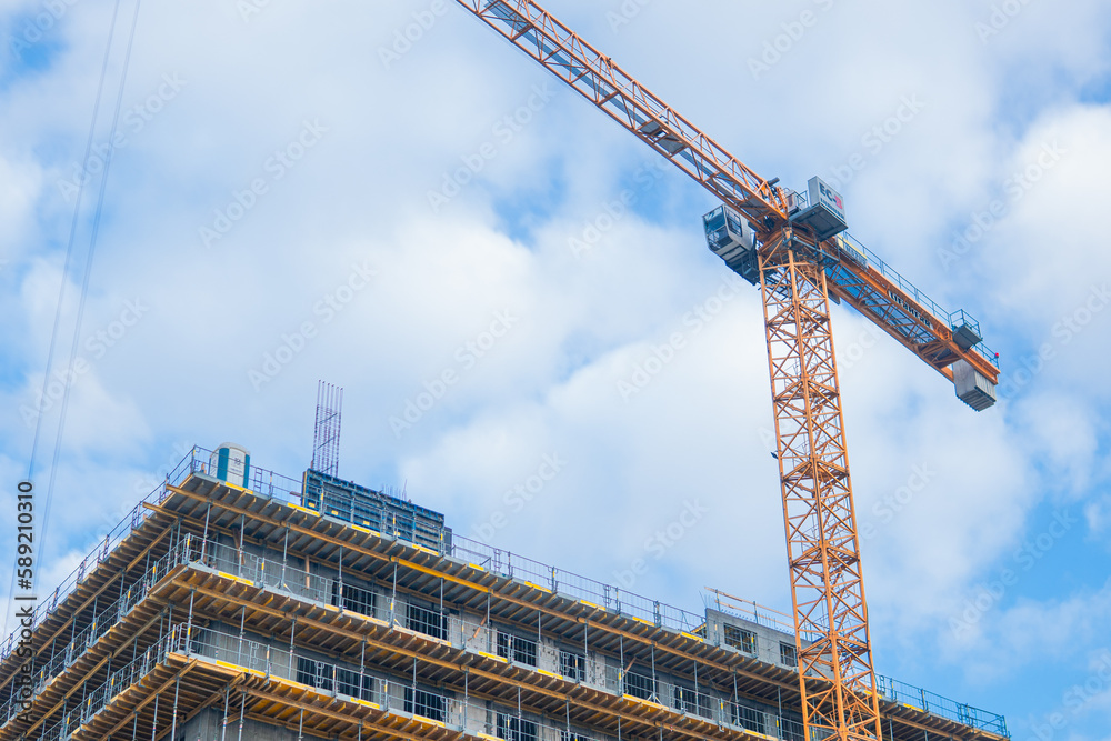 construction cranes at a building under construction