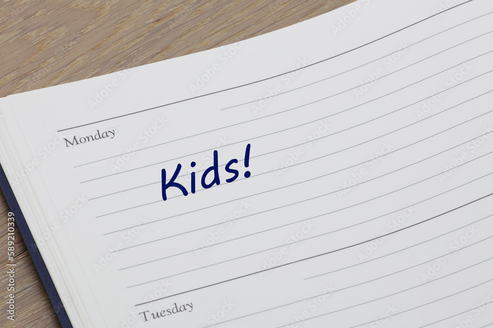 Kids reminder note in blue ink in a diary page Kids reminder note in blue ink in a diary page