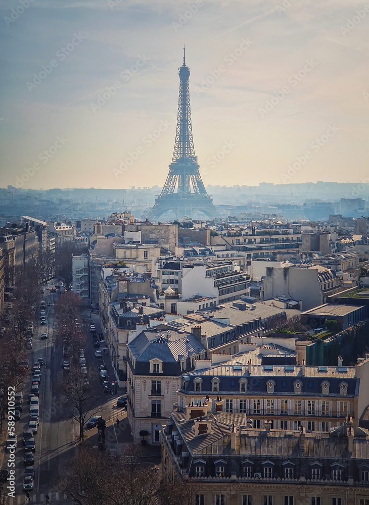 Paris cityscape with view to the Eiffel Tower, France. Beautiful parisian architecture with historic buildings, landmarks and busy city street. Aerial vertical background