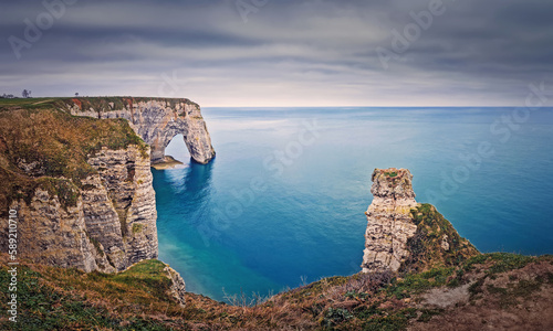 Beautiful view to the Porte d'Aval natural arch at Etretat famous cliffs in Normandy, France
