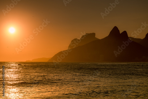 Sunset or sunrise in a orange sky at Arpoador beach