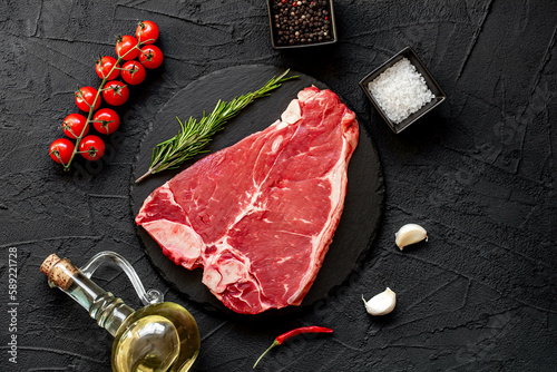 raw T-bone steak on stone background